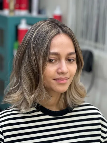 The client looking happy and confident with her new blonde look.