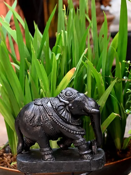 A small, ornate black stone elephant, perfect for adding a touch of tradition to a planter or a nook. This piece was part of my festive decor collection, inspired by the rich culture of our past and present.