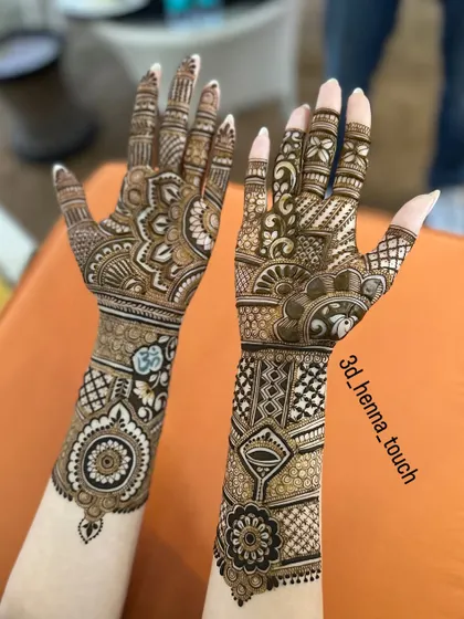 The back-hand view of a stunning bridal design. The patterns extend up the arm, featuring a mix of mandalas, geometric shapes, and traditional Indian motifs.
