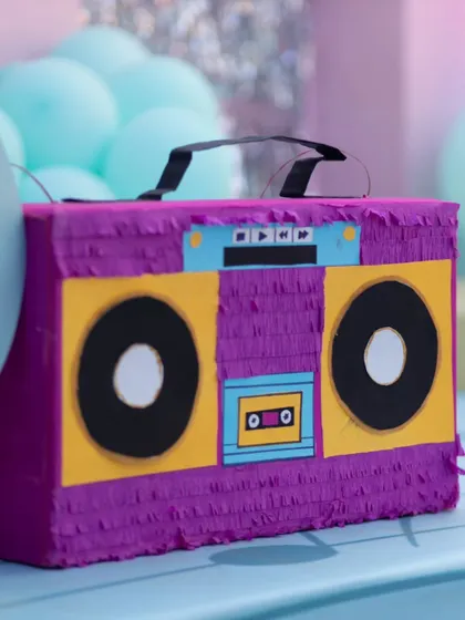 A handcrafted boombox piñata, made by the birthday girl's talented mom, added a personal and fun touch to the musical celebration.