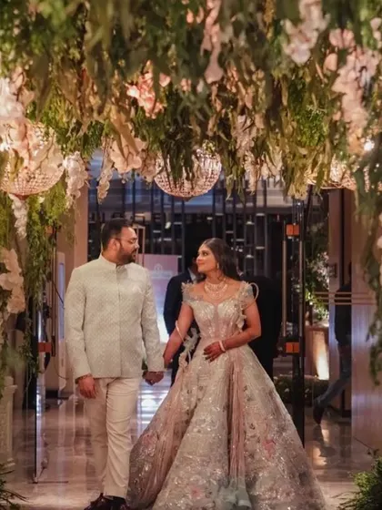 I love bringing fairy tales to life. For this engagement, I designed an enchanted forest entryway with a lush canopy of hanging greenery, white orchids, and sparkling chandeliers, making the couple's entrance truly magical.