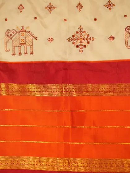 The full pattern of the Kasuthi embroidery on the white Kanjivaram body, a beautiful blend of two distinct weaving and embroidery traditions.