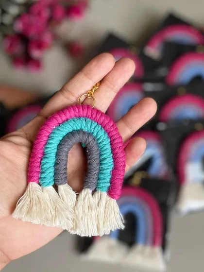 A bright and fun rainbow keychain with pink, grey, and teal.