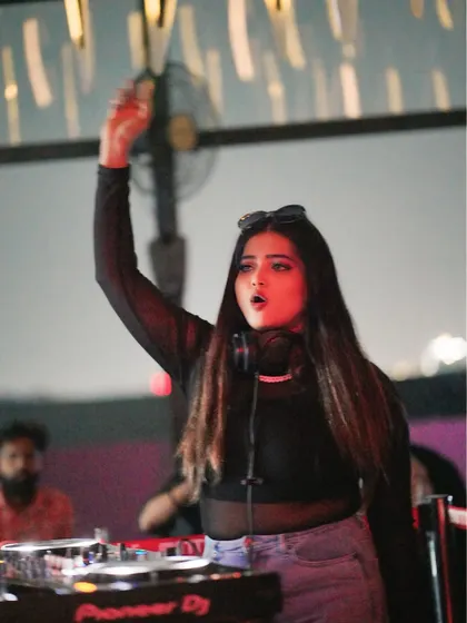 Hyping up the crowd from the DJ booth. An essential part of my performance is engaging directly with the audience to build excitement.