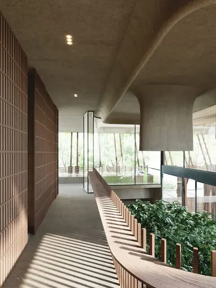 A view from the upper walkway in The Sanctuary. The interior is characterized by flowing forms, warm wood textures, and a constant connection to the central courtyard, reinforcing the feeling of a peaceful, green retreat.