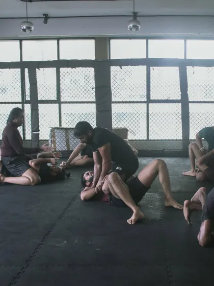Another angle of our grappling class. The entire mat is filled with students learning and applying BJJ techniques.