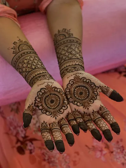 This version of the mandala design includes personalized names, "Jawahar" and "Alefiyah," written in a beautiful script around the central circle.