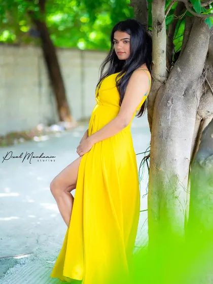 A bright yellow dress against the green foliage. This shot shows how we can use natural elements and props to create a vibrant, story-driven image.