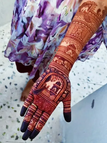 The beauty of a rich, dark henna stain. This traditional design features a doli, elephants, and intricate patterns, and the final color is a testament to our 100% natural henna.
