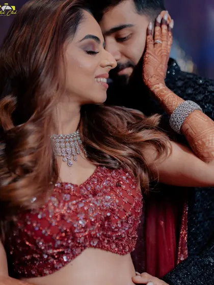 An intimate sangeet portrait, capturing the tender connection between the couple. Her hand on his cheek, his smile says it all.