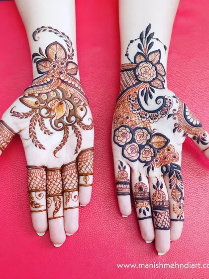 A stunning example of two different yet complementary designs on each hand. One hand has a bold Arabic style, while the other features more traditional Indian floral patterns.