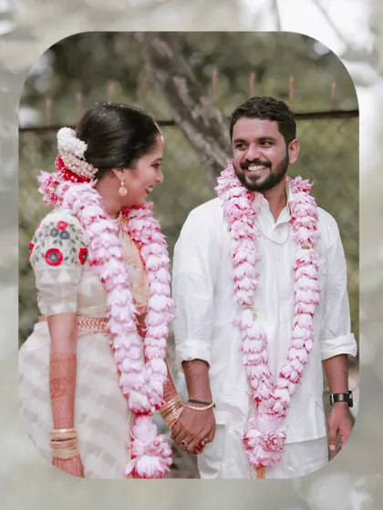 A beautifully framed portrait of the couple, their happy faces surrounded by soft, natural greenery.