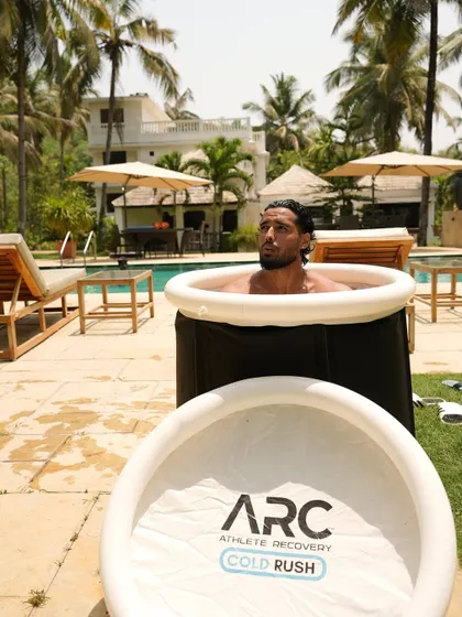 An athlete takes a well-deserved ice bath at our Goa camp. This recovery method is a critical part of our program, helping to reduce muscle soreness and speed up recovery after intense training.