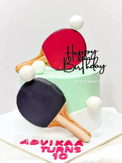 A cake for a table tennis player turning 10. The rackets are handmade from fondant, and the design is clean and sporty.