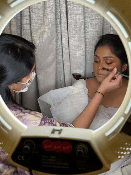 A behind-the-scenes look through the ring light as I work on a bridal demonstration.