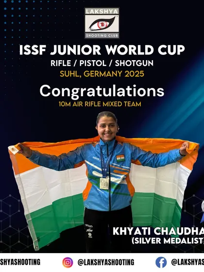 Khyati Chaudhary celebrating her silver medal win for India at the ISSF Junior World Cup, holding the national flag with pride.