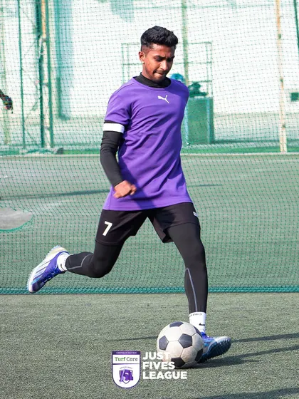 A player in full stride, controlling the ball and looking for an opportunity. The quality of play is a testament to the talent within the corporate world.