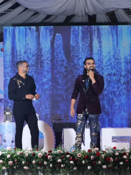 On stage with a client during a first birthday party, ensuring the event is memorable for the parents too.
