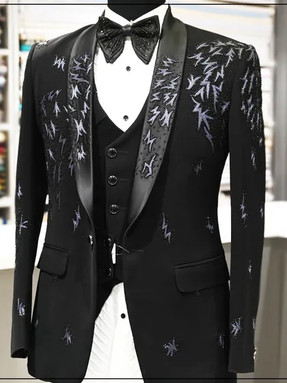 This black three-piece tuxedo is for the bold. It features abstract, lightning-like embroidery in a contrasting thread, creating a dynamic and energetic look.