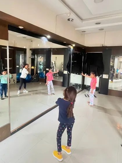 A group of young students learning choreography in front of the studio mirror. Watching their reflection helps them understand posture and movement, which is a key part of my teaching method.
