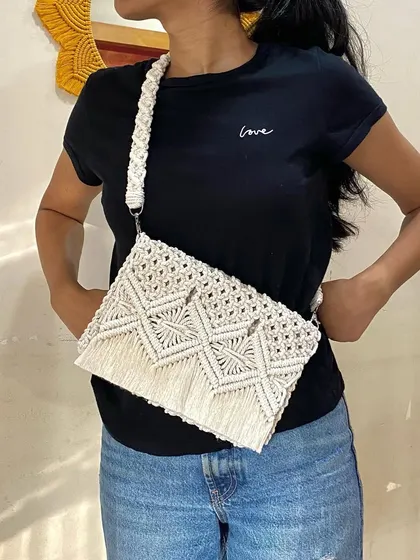 A closer look at the off-white macrame cross-body bag. The intricate knot work is what gives this bag its unique texture and boho-chic feel.
