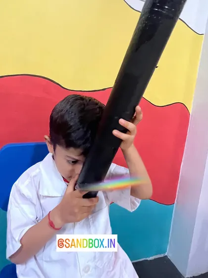 This child is captivated by the rainbow he has created. Our hands-on approach helps demystify complex topics like light refraction and spectrums.