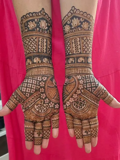 A gorgeous design for a bride or siders, featuring peacocks on the palms and bands of elephants and lotuses on the wrists.