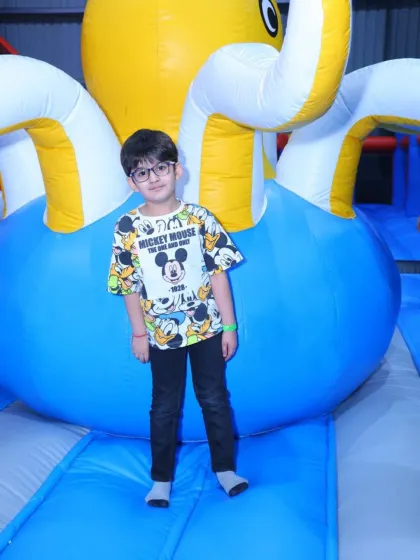 Posing with a giant inflatable octopus, one of the many fun characters you'll find in our play kingdom.