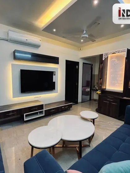 A complete view of the living room, showing how the sofa, TV unit, and temple area are arranged to create a balanced and harmonious space.
