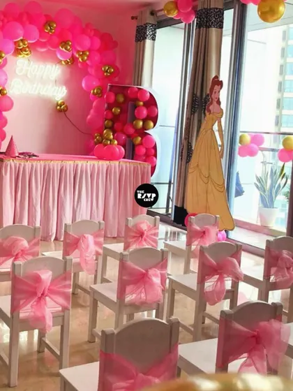 Tiny thrones for little royalty. This Belle-themed party featured kid-sized chairs with pretty pink sashes and a 'Happy Birthday' neon sign.