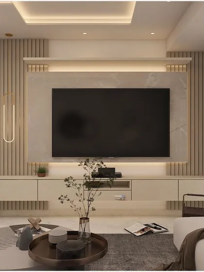 A monochromatic TV unit with a fluted back panel and a floating cabinet for storage. The warm under-lighting adds a cozy glow to the living space.