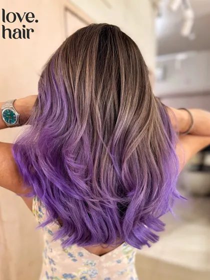 When you can't decide, mix them both. We blended a cool ash brown balayage with a vibrant purple for a look that's the best of both worlds: natural and edgy.