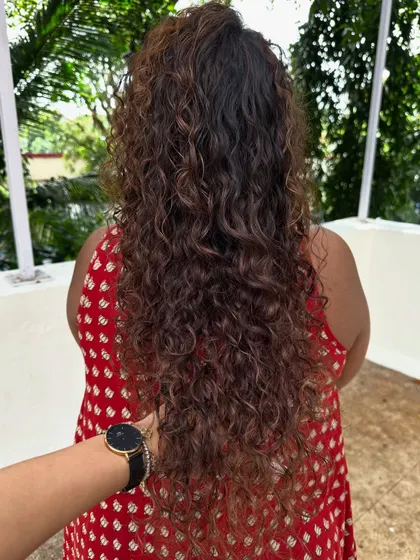 Look at that healthy shine and definition. Proper cutting and coloring techniques are key to keeping curly hair looking its best.