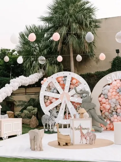 A wide shot of the entire pastel jungle setup, including the balloon train, showcasing the grand scale and thoughtful layout of the party decor.