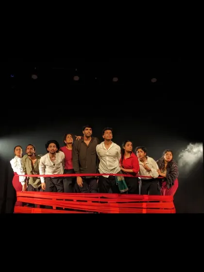 The full cast on stage, using props and their collective presence to create a powerful and memorable image in 'Sea's Fire'.