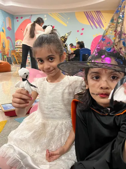 Two friends showing off their ghost lollipops. Our Halloween event is a great opportunity for kids to have fun and make new friends.