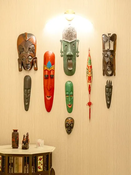 We often use art to reflect a client's personality and travels. This collection of decorative masks from various cultures creates a rich and personal focal point on this wall.