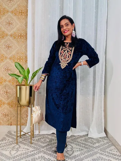 A royal blue velvet kurta with intricate embroidery around the neck. This is a stunning piece that is sure to make you feel like royalty.