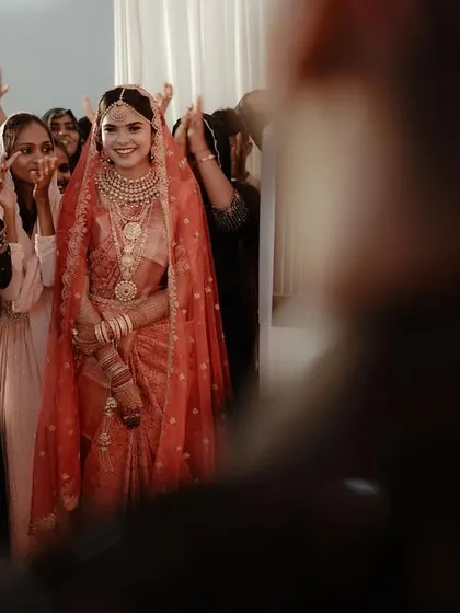 The bride's entrance is a magical moment. This shot captures her radiant smile as she is welcomed by her loved ones.