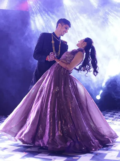 A single, powerful shot of a couple's dance performance. The dip, combined with the smoky, backlit stage, creates a dramatic and memorable photograph that feels like a scene from a movie.