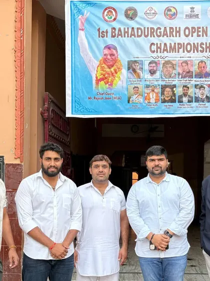 Standing with fellow coaches and organizers outside the venue for the 1st Bahadurgarh Open Khel Karate Championship.