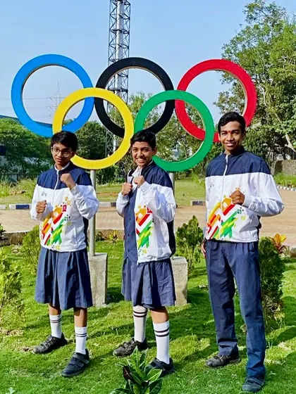 Our three young champions in front of the Olympic rings. This is the ultimate dream.