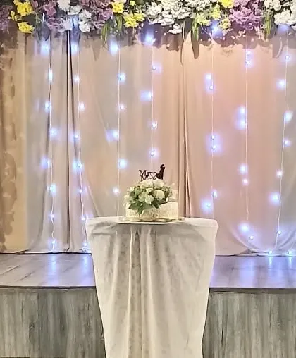A close-up of the wedding cake against a backdrop of fairy lights. It's all in the details.