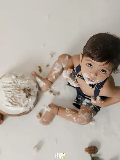 An overhead shot showing the glorious mess of a first birthday cake smash.