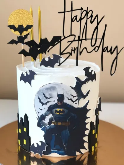 A Batman-themed cake for the dark knight, featuring the Gotham city skyline and the classic bat symbol.