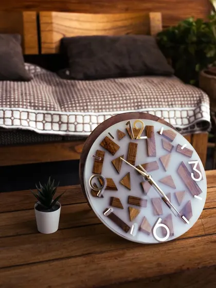 A beautifully styled shot of the wood and resin clock on a side table. The combination of natural wood and modern resin makes it a versatile piece that fits many interior styles.