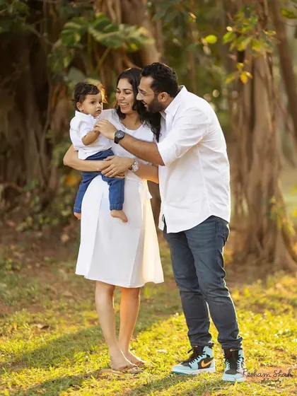 A quiet, loving moment between a family of three, surrounded by the beauty of nature.
