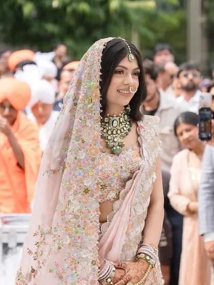 A close up of Tanisha walking down the aisle, her soft makeup looking flawless and radiant.