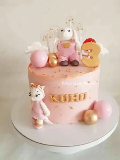 A sweet and simple cake for a 3rd birthday. This pink cake is decorated with cute, hand-crafted animal figurines and gold accents.