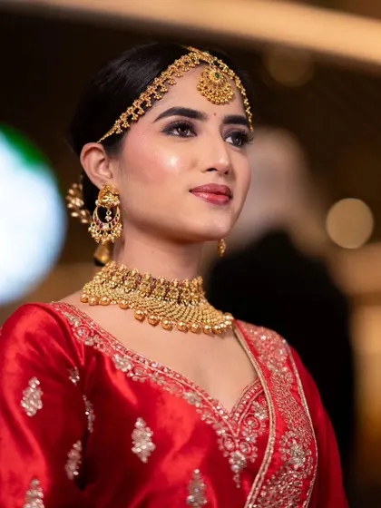 This royal bridal look was created for my Nykaa masterclass. It features a classic red lehenga, gold jewellery, and elegant makeup with a soft smokey eye and a neutral lip.